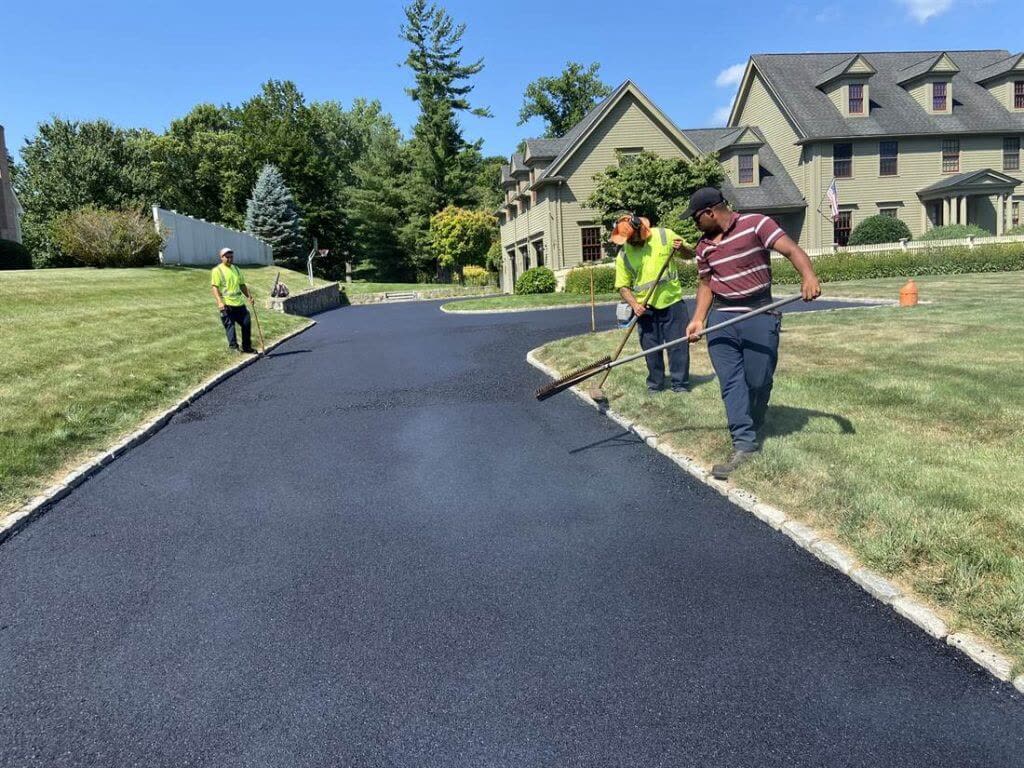 A Team Asphalt crew raking fresh asphalt